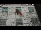 Dramatic rescue footage: Firefighters grab woman about to jump off building